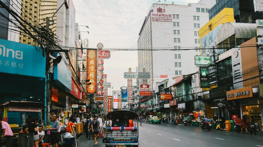 Travellers walking along a busy street in Thailand