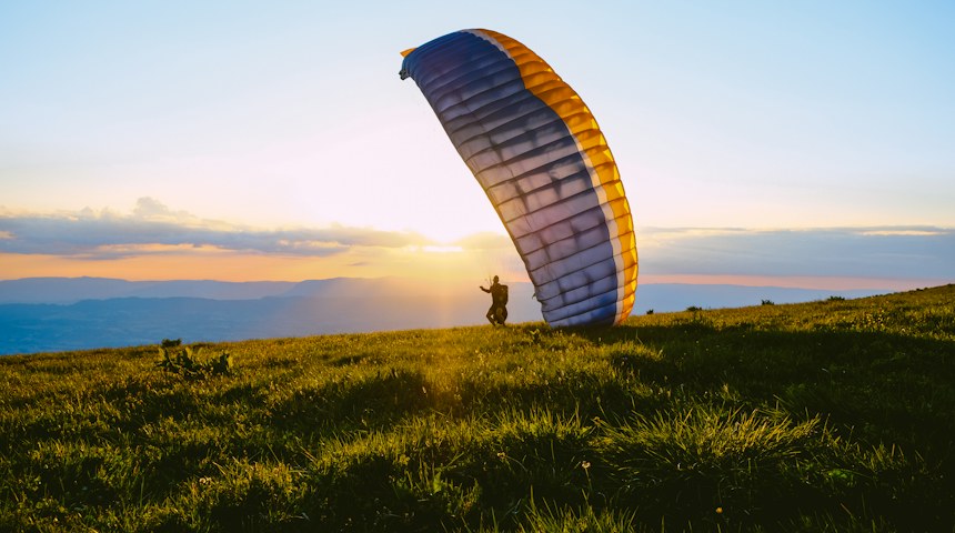Paraglider flying above the mountains