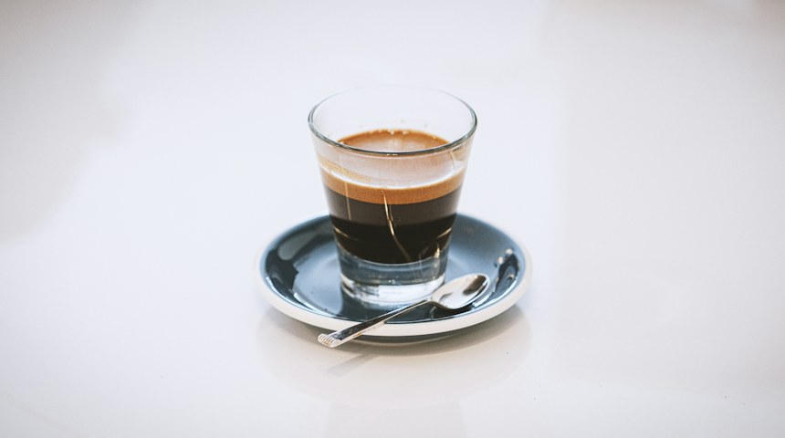 Espresso served in a glass cup at an Italian cafe