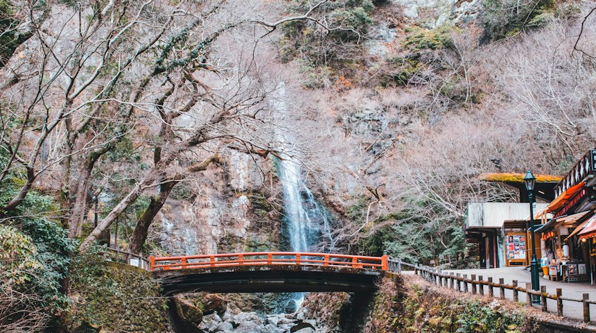 Wooden bridge near a rushing waterfall on a Japanese hiking trail