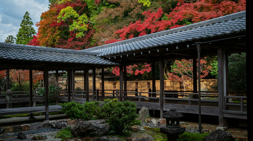 Wooden covered walkway through a peaceful Japanese garden