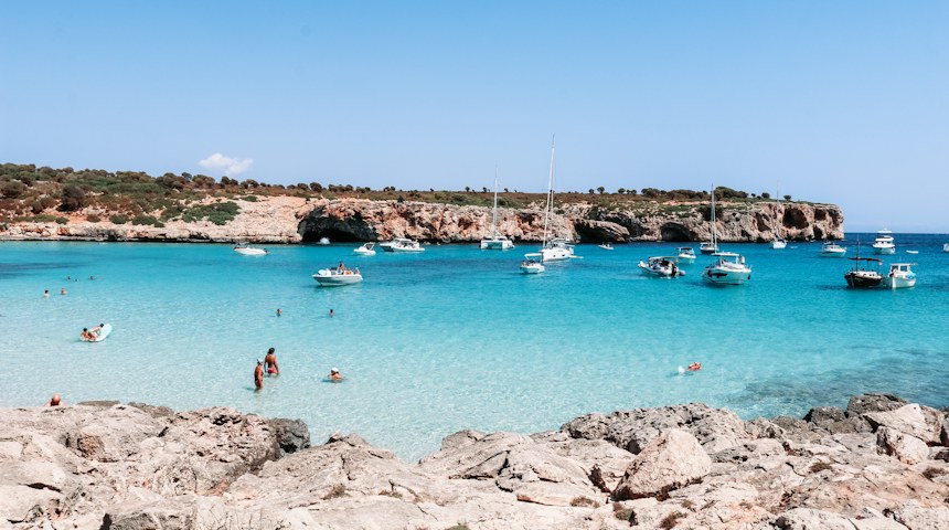 Swimmers in a turquoise bay on Mallorca