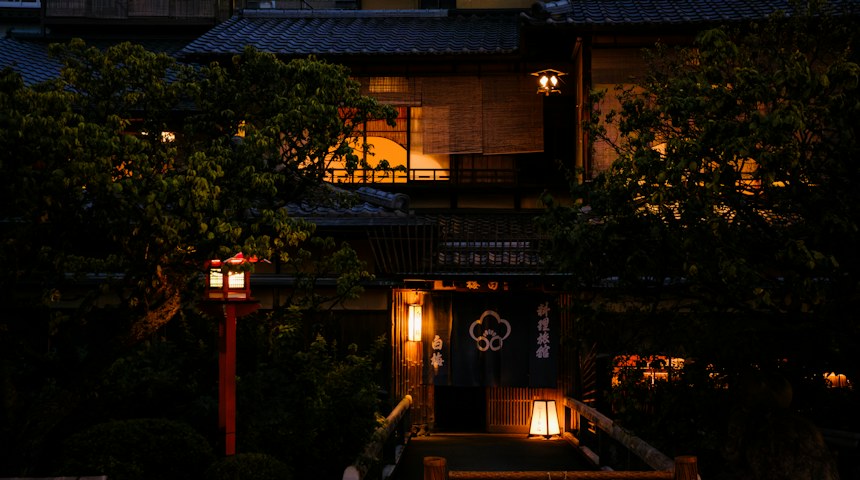 Traditional Japanese ryokan building illuminated in the evening