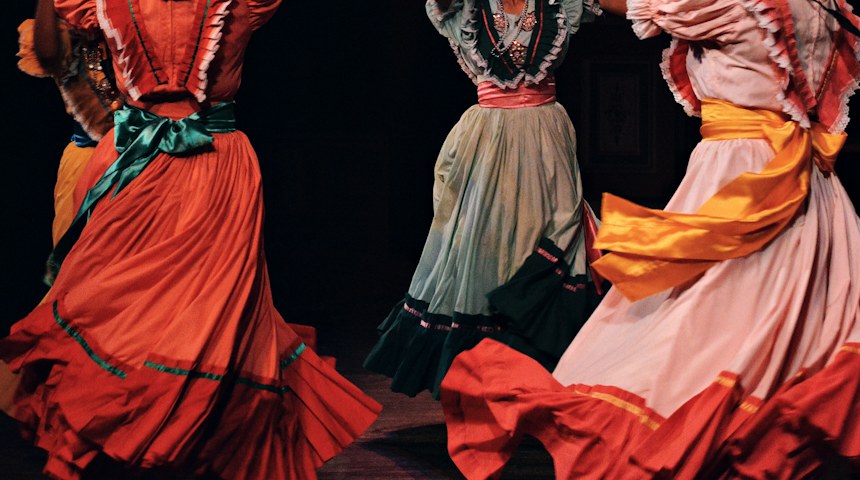Flamenco dancers performing in traditional dresses