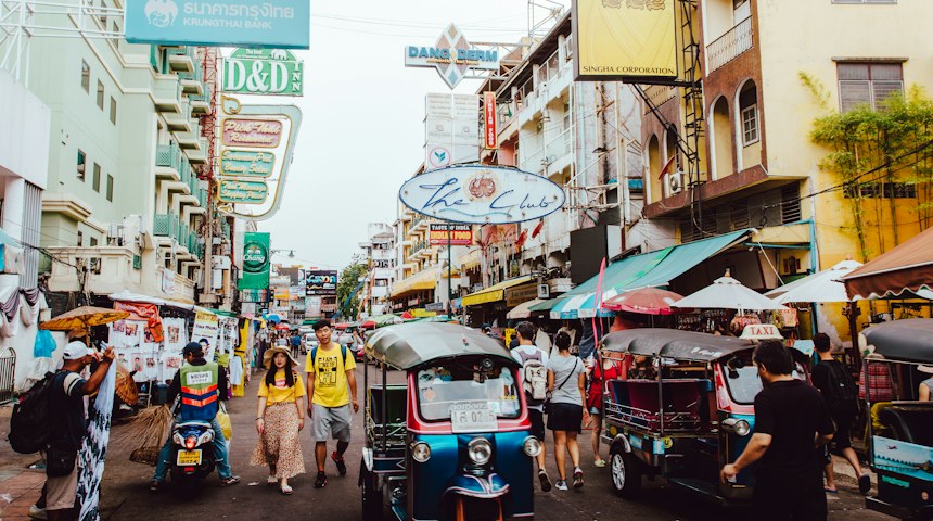 People walking through a busy street in Bangkok