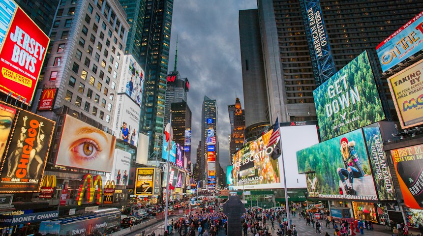 Crowds walking through Times Square in New York City