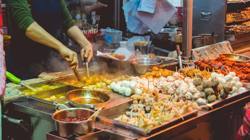 Street food vendor cooking at a stall in Thailand