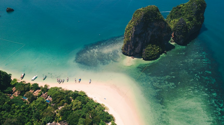 Aerial view of turquoise water and limestone islands in southern Thailand