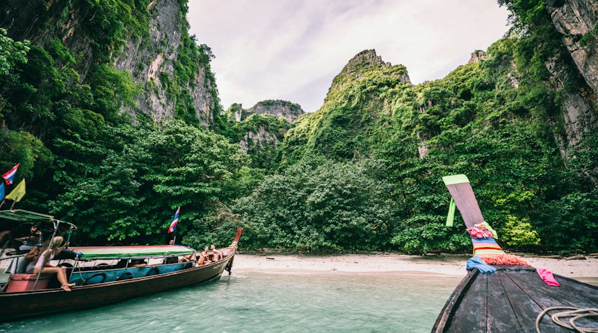 Passenger boat travelling along a river in Thailand