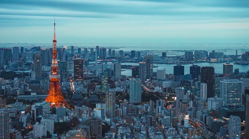Tokyo Tower illuminated at night above the city skyline