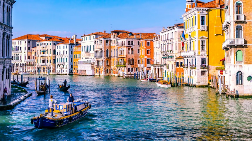 Canal lined with colourful buildings in Venice